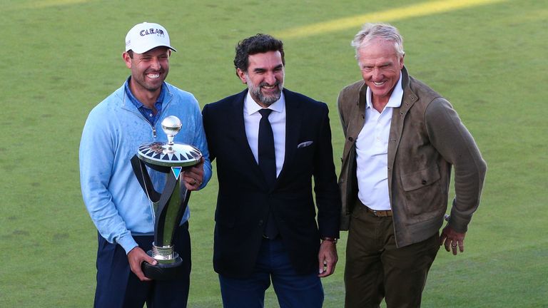 Charl Schwartzel, Yasir Al-Rumayyan and Greg Norman standing on the final green of the Centurion Club at the end of the first LIV Golf Invitational