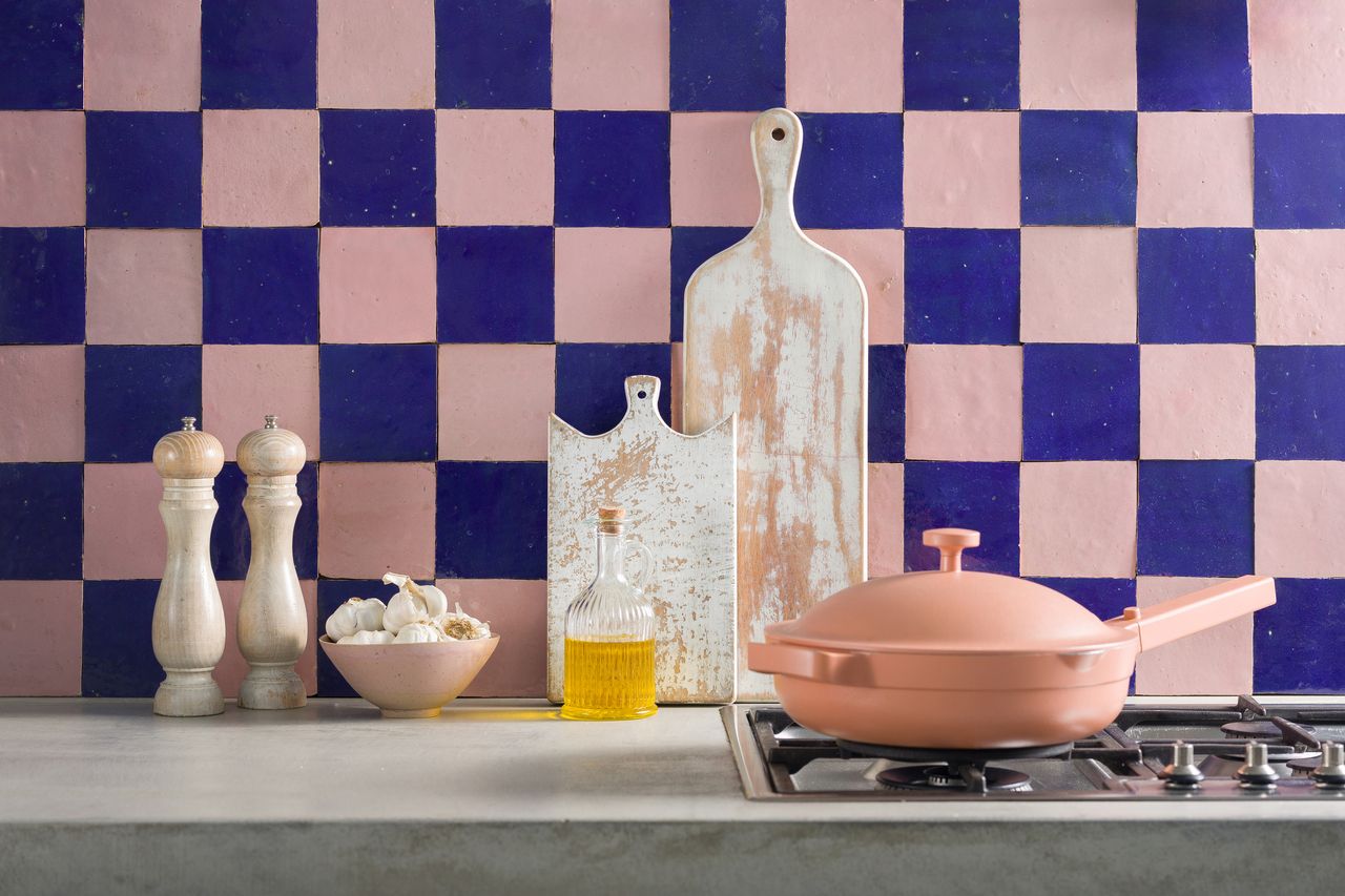 A kitchen with a blue and pick checked backsplash