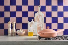 A kitchen with a blue and pick checked backsplash