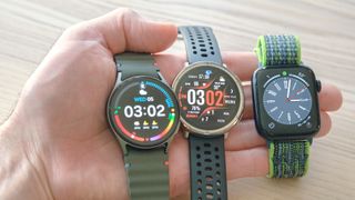 Close-up of the Samsung Galaxy Watch 7, Amazfit Active 2 and Apple Watch SE in the palm of a user's hand