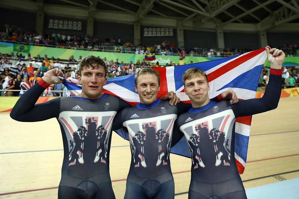 Callum Skinner, Jason Kenny and Philip Hindes of Great Britain celebrate after winning gold and getting an Olympic record in the Men's Team Sprint