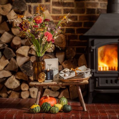 flower in vase with fireplace and brick walls