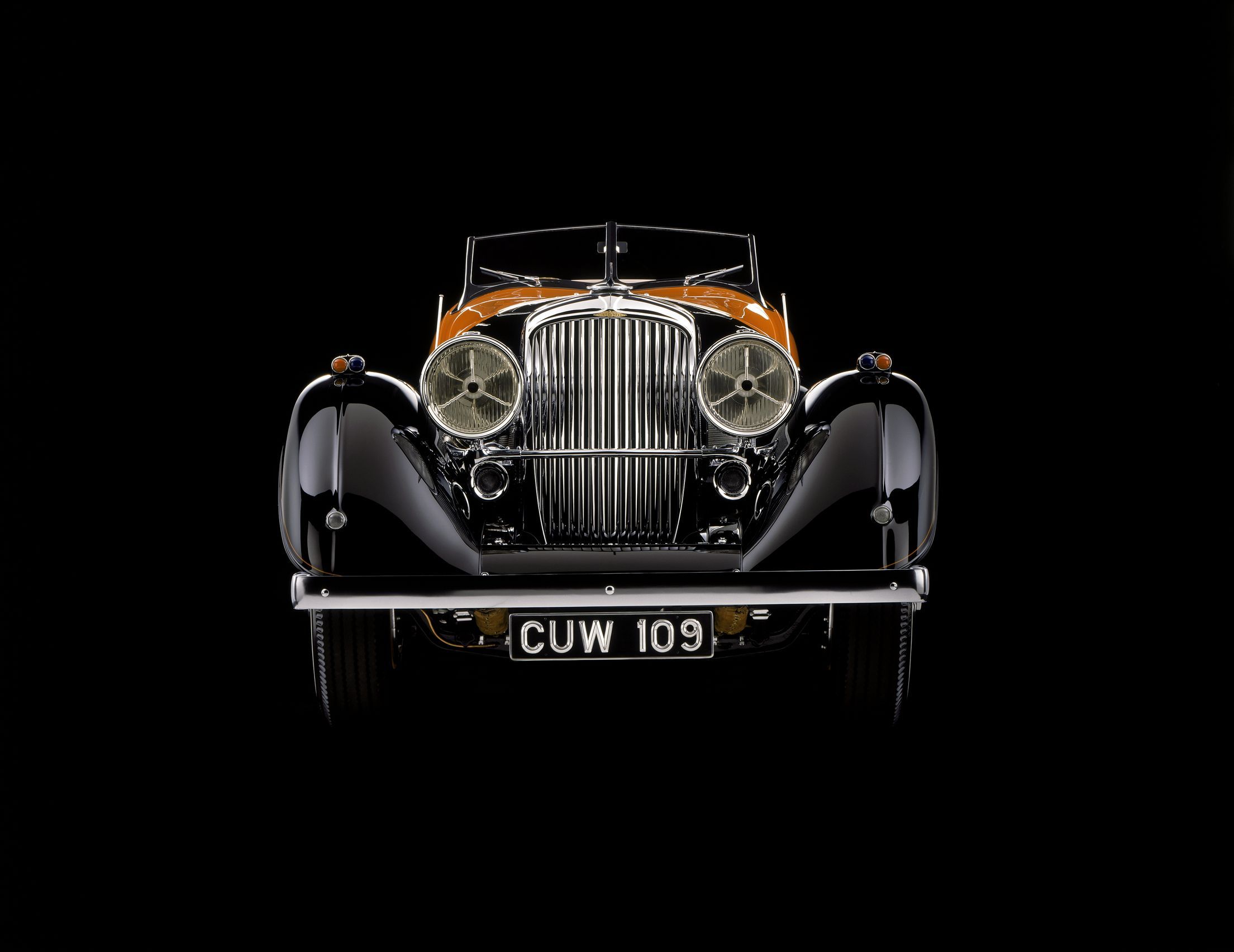 Details of the orange and black Duesenberg. it looks like something Al Capone would drive