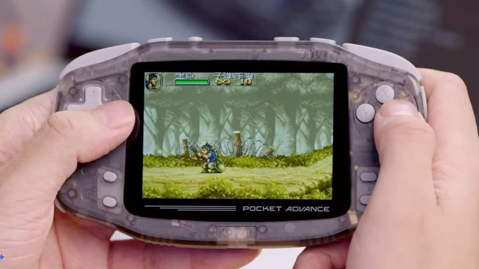 Hands holding KONKR Pocket Advance Onxy Ice with Metal Slug playing on screen.