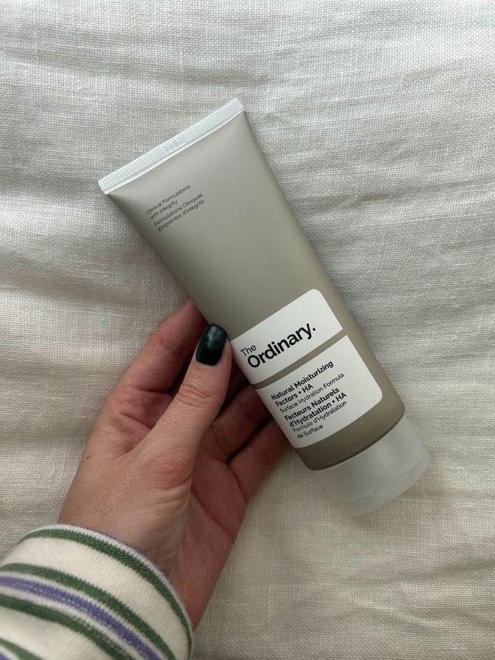 Junior beauty editor Grace Lindsay holding The Ordinary Natural Moisturising Factors + HA