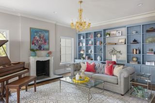 A living room with blue painted bookshelf