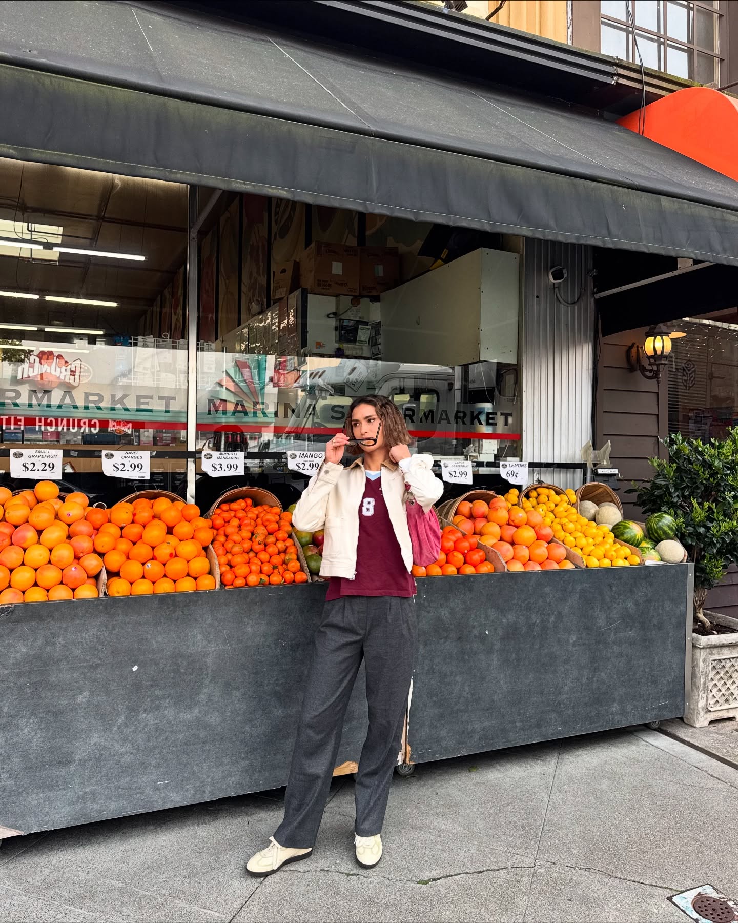 Caitlin Miyako outside orange stand