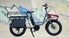 Cropped wide shot of the Benno RemiDemi XL against the backdrop of a concrete skatepark