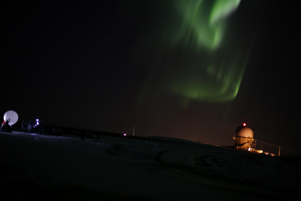 Researchers prepare to launch an instrument-laden weather balloon toward Alaska's aurora on April 12, 2012 (at right is a radar facility).