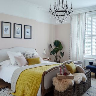 bedroom with white wall and chandelier