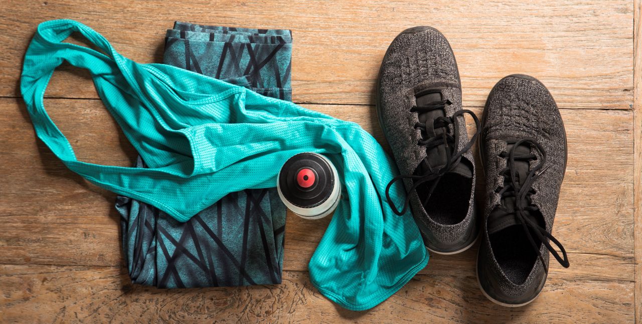 fitness sports clothes and shoes on a wooden floor