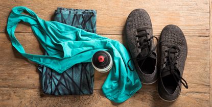 fitness sports clothes and shoes on a wooden floor