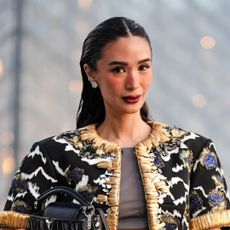 Heart Evangelista wears silver earrings, slicked back hair, detailed jacket in front of the louvre - best skinceuticals products