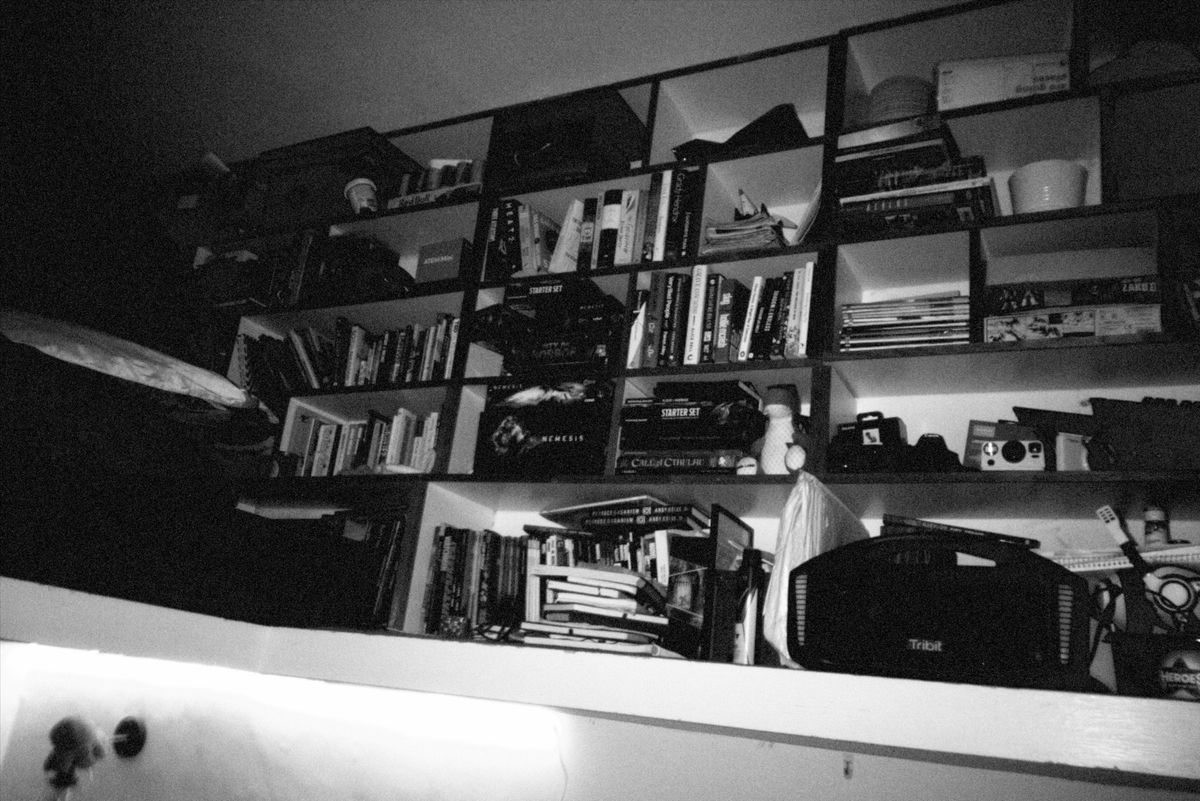 Grainy black and white photo of bookshelves at a house party during Christmas taken with the Flashback ONE35 redisposable digital camera