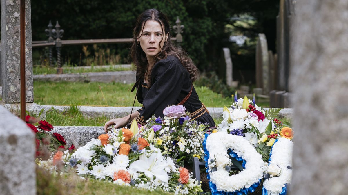 Elaine Cassidy as Sarah Fenn, sitting amongst flowers in a cemetery in Sanctuary: A Witch&#039;s Tale