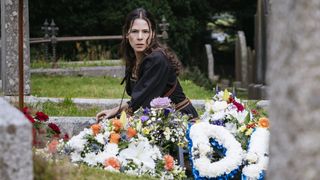 Elaine Cassidy as Sarah Fenn, sitting amongst flowers in a cemetery in Sanctuary: A Witch's Tale