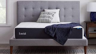 Lucid 10 Inch Queen Hybrid Mattress on a fabric bed base in a blue bedroom