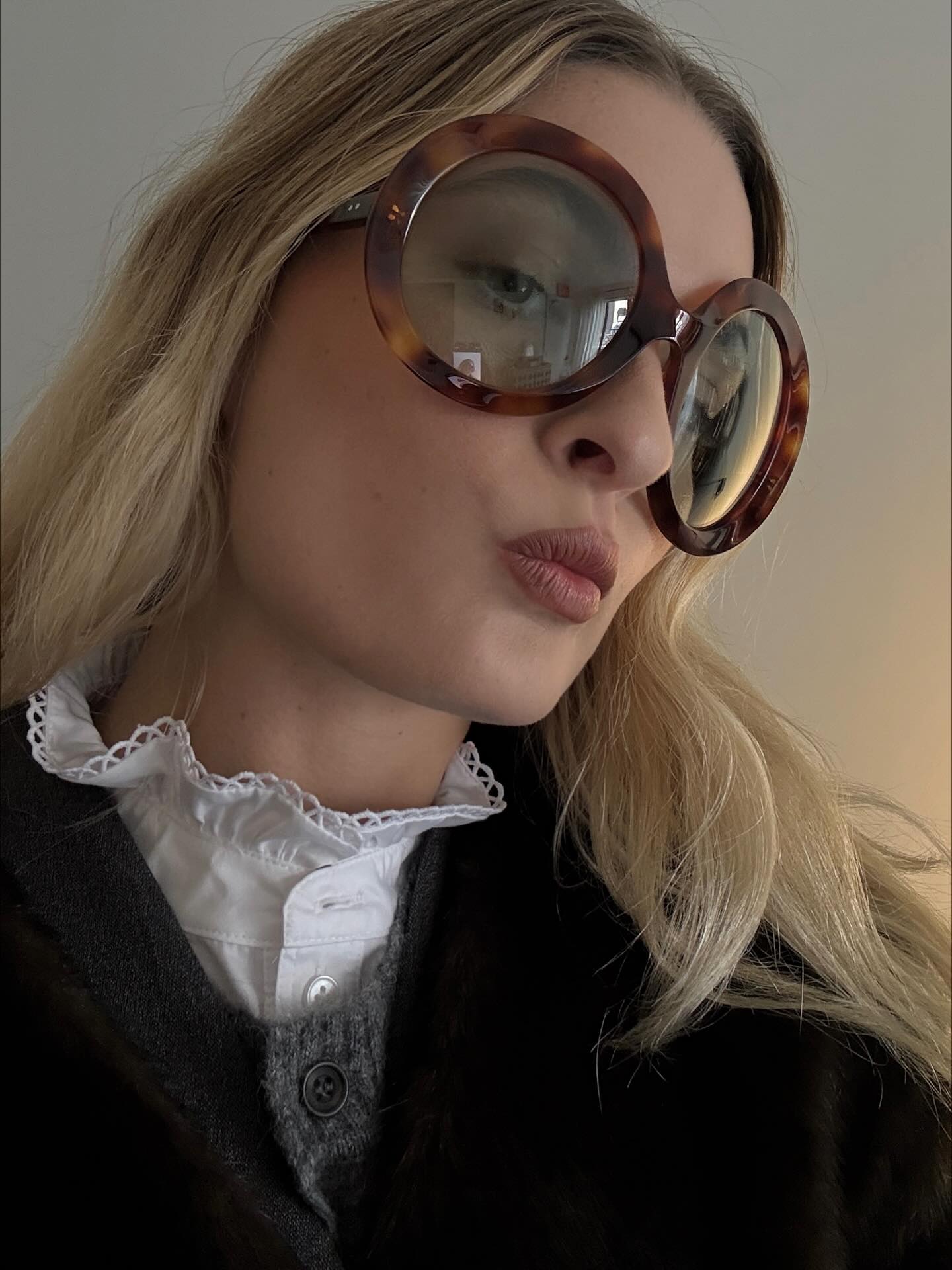 An image of @christietyler wearing tortoiseshell sunglasses, one of the biggest animal print trends of 2026.