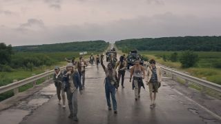 the long walk boys on the road looking tired with hills and skies in the background
