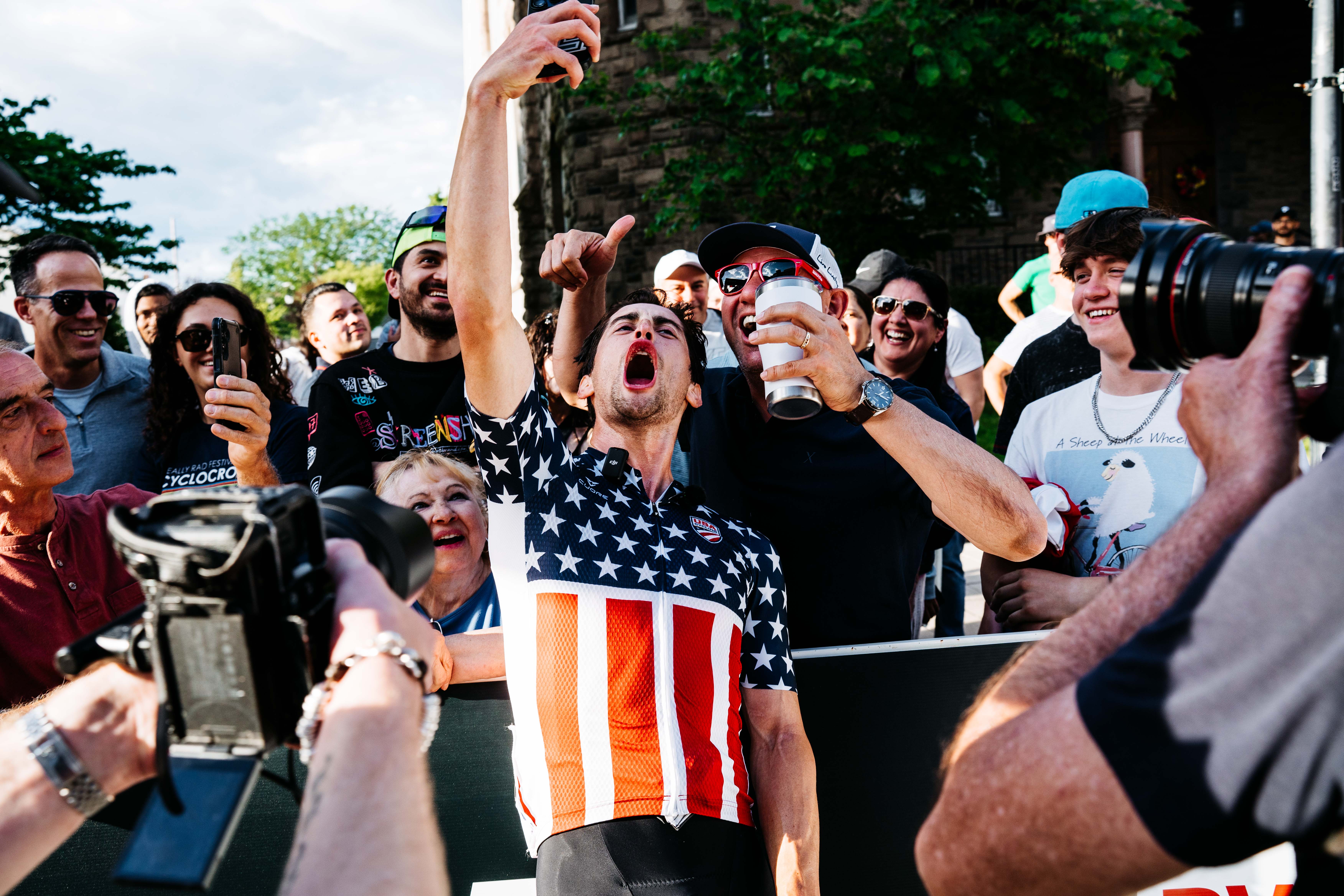 Elite men&#039;s winner Lucas Bourgoyne celebrates with the crowd in Somerville