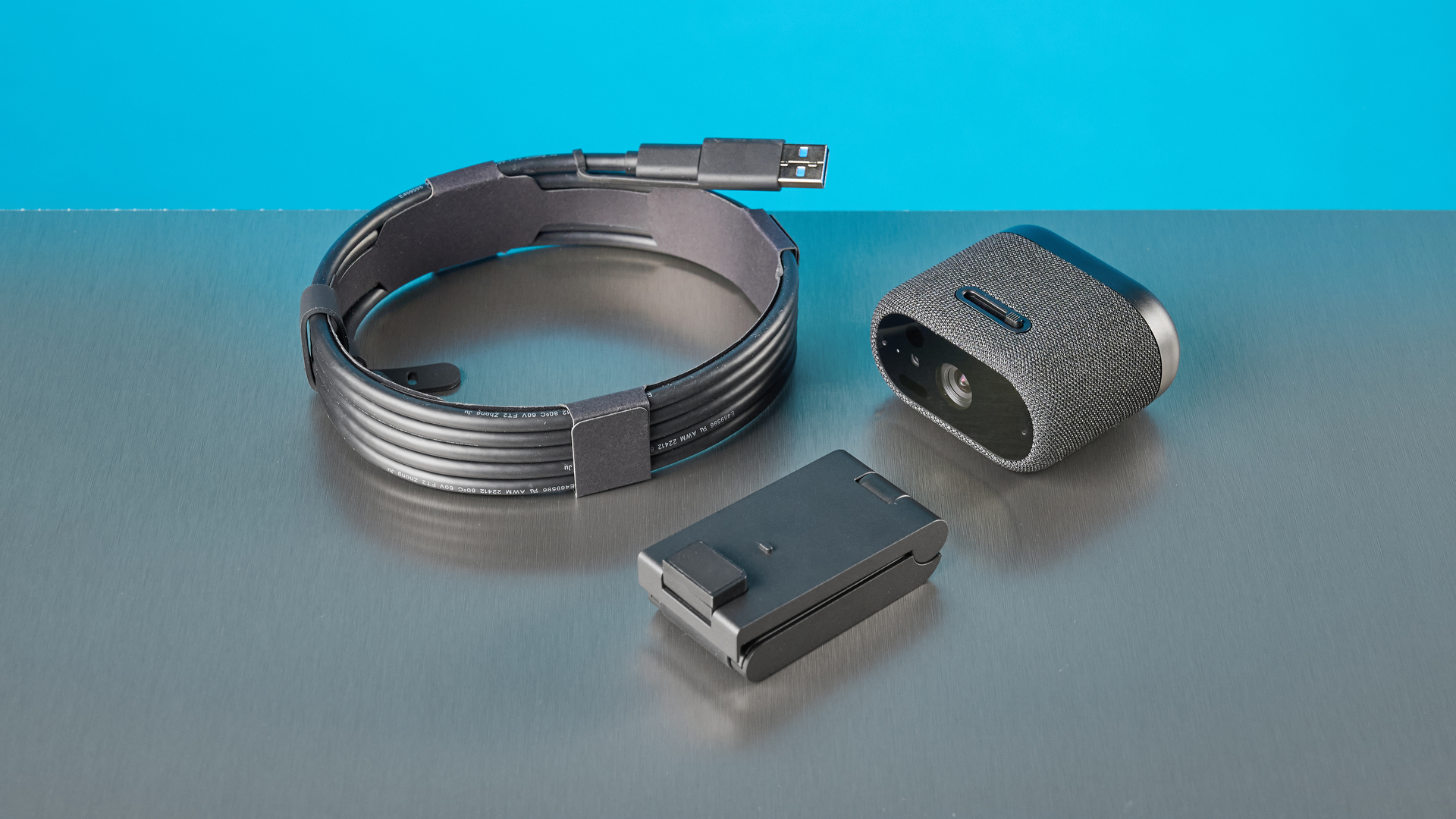 Dell Pro 7 Webcam photographed in front of a blue background