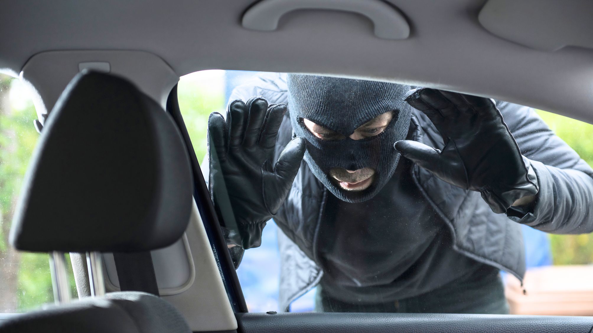 Thief peeking into a car