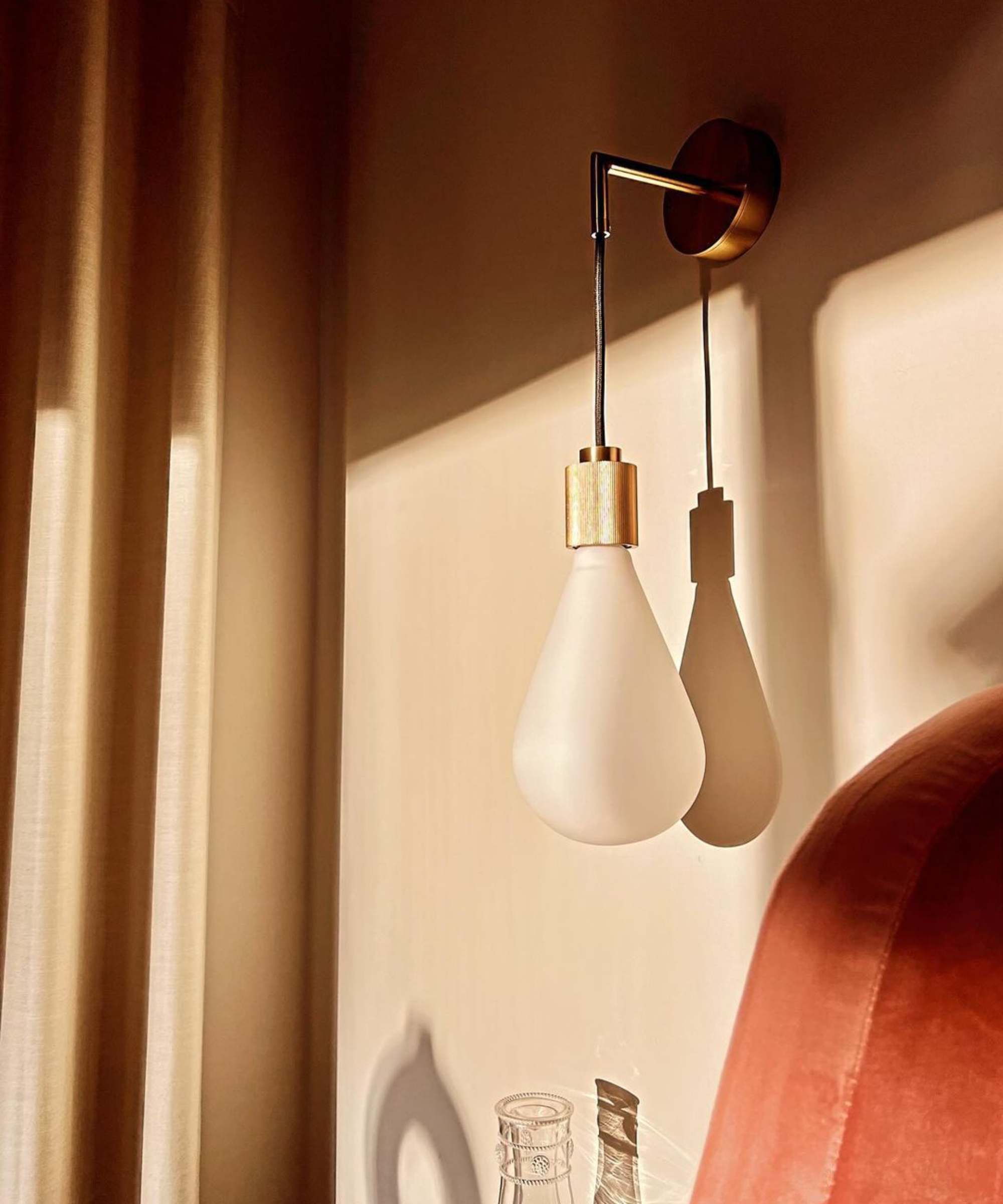 gold and white glass light bulb shaped wall light