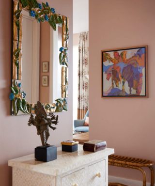 Pink entryway with vintage mirror
