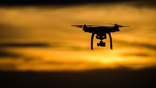 Can you fly a drone at night? image shows drone flying against sunset
