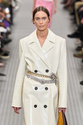 Model wears a chain belt on the Miu Miu runway.