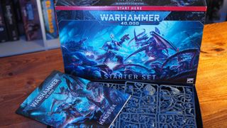 Warhammer 40,000 Starter Set and contents sat on a wooden table