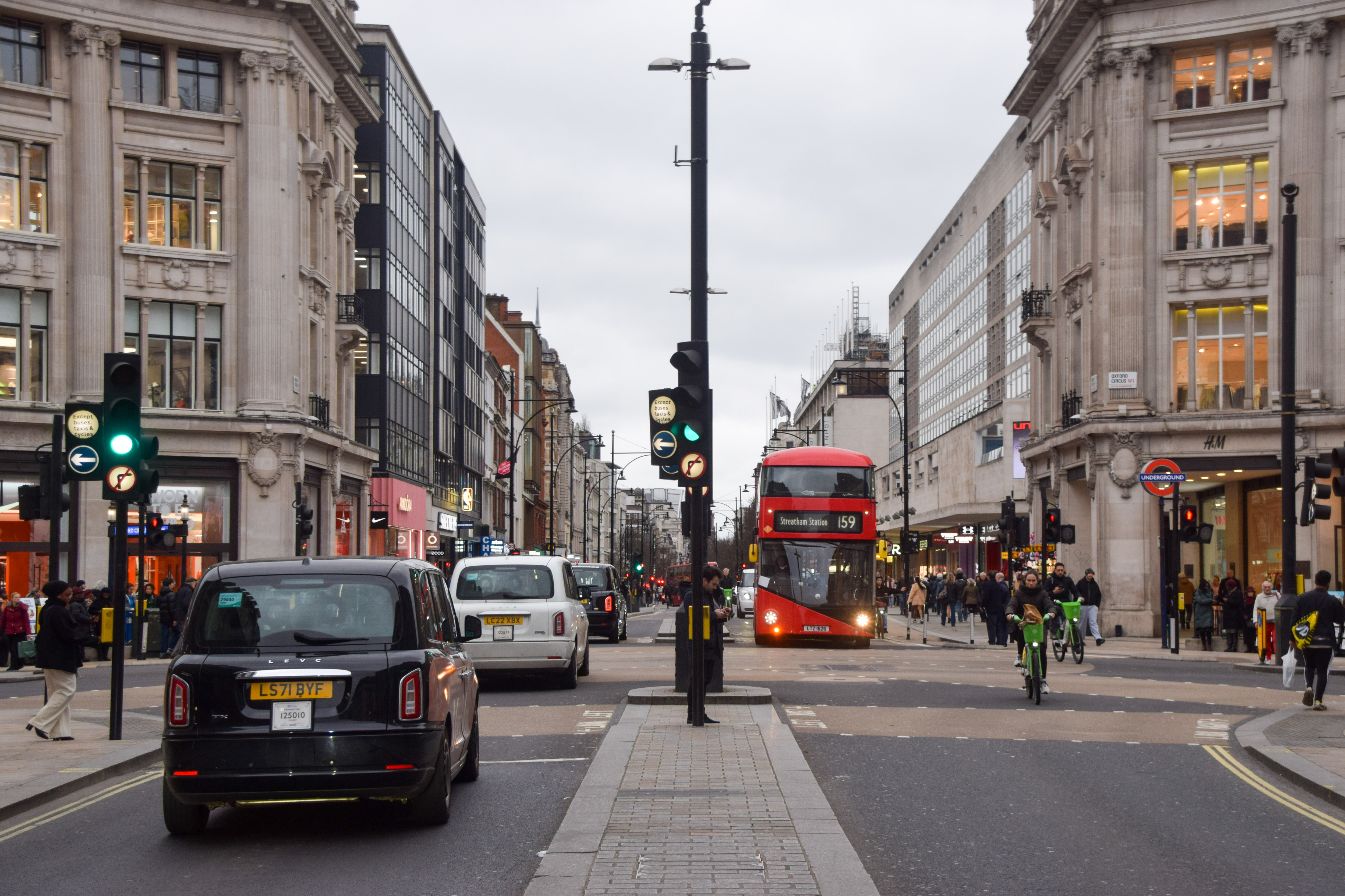 Taxis and buses pass through Oxford Street as London Mayor Sadiq Khan gives the official go-ahead for part of the busy shopping street to be pedestrianised.