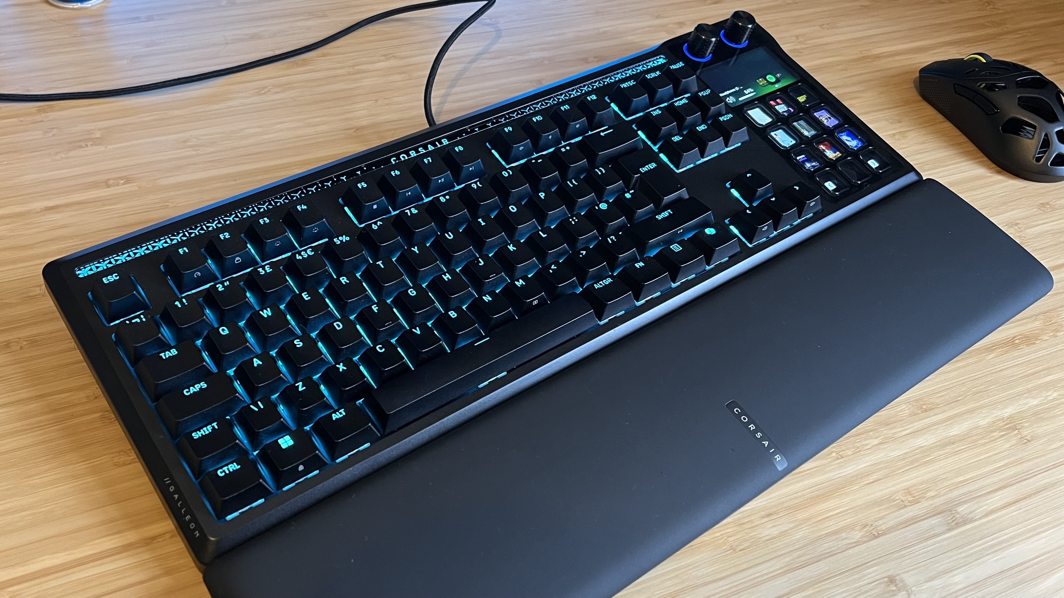 Corsair Galleon 100 SD gaming keyboard set up on wooden desk with wrist rest and mouse