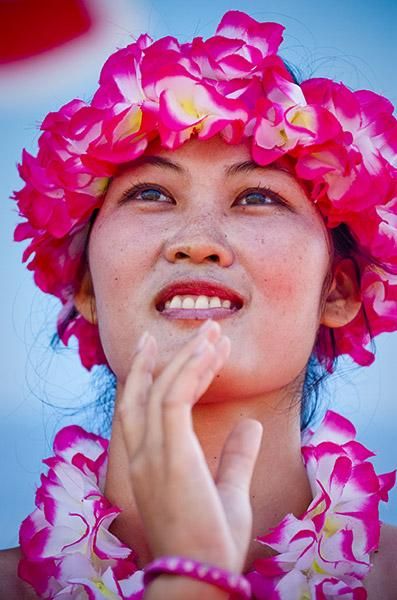 A local dancer awaits the start to her routine in Sanya.