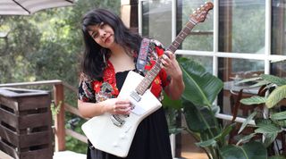 Katherine Paul holds her Ernie Ball Music Man St. Vincent signature guitar