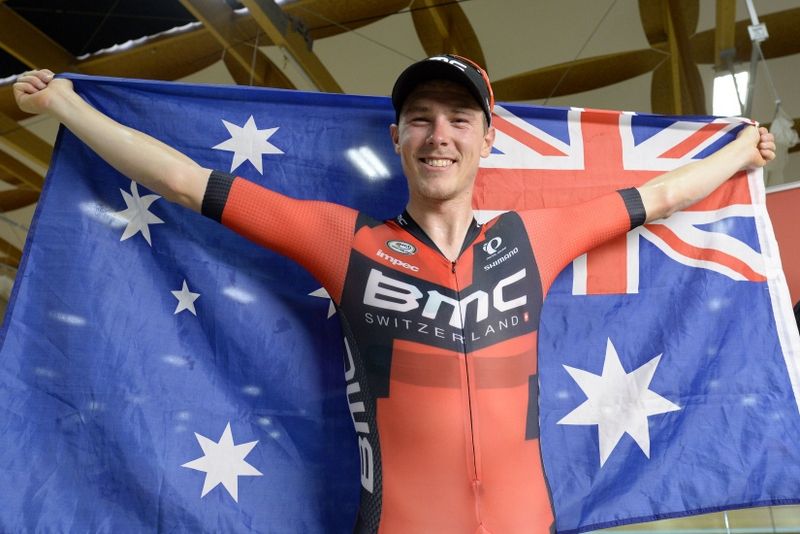 Rohan Dennis with an Australian flag after his world record feat