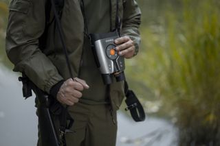 an individual holding the DVX Night Vision - Night Storm X1