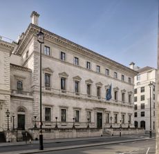 Fig 2: The street frontage of the club with its balcony windows. This was regularly decorated for public events as a state thoroughfare. To the left is the porch to the rented chambers that separate the Reform from the Travellers Club. The building to the right replaced the Carlton Club, which was badly damaged by bombing. The Reform Club, Pall Mall, St. James's, London SW1. Photographed by Will Pryce for Country Life. ©Country Life