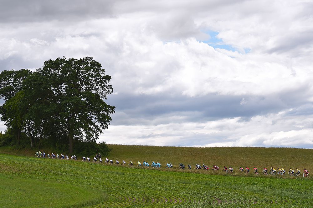 The peloton rolls through the countryside during stage 4 at the Tour de Suisse