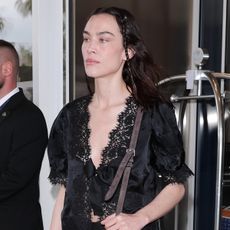 Alexa Chung wearing a black lace top in Cannes