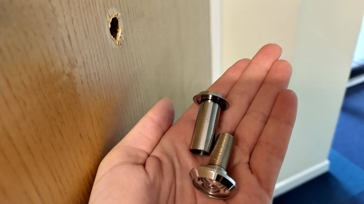 Original peephole removed from door before installing Ezviz Wire-Free Peephole Door Viewer EP4