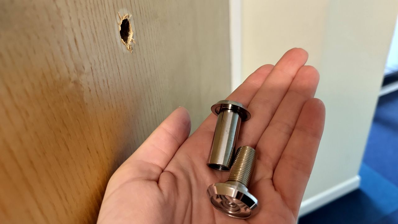 Original peephole removed from door before installing Ezviz Wire-Free Peephole Door Viewer EP4