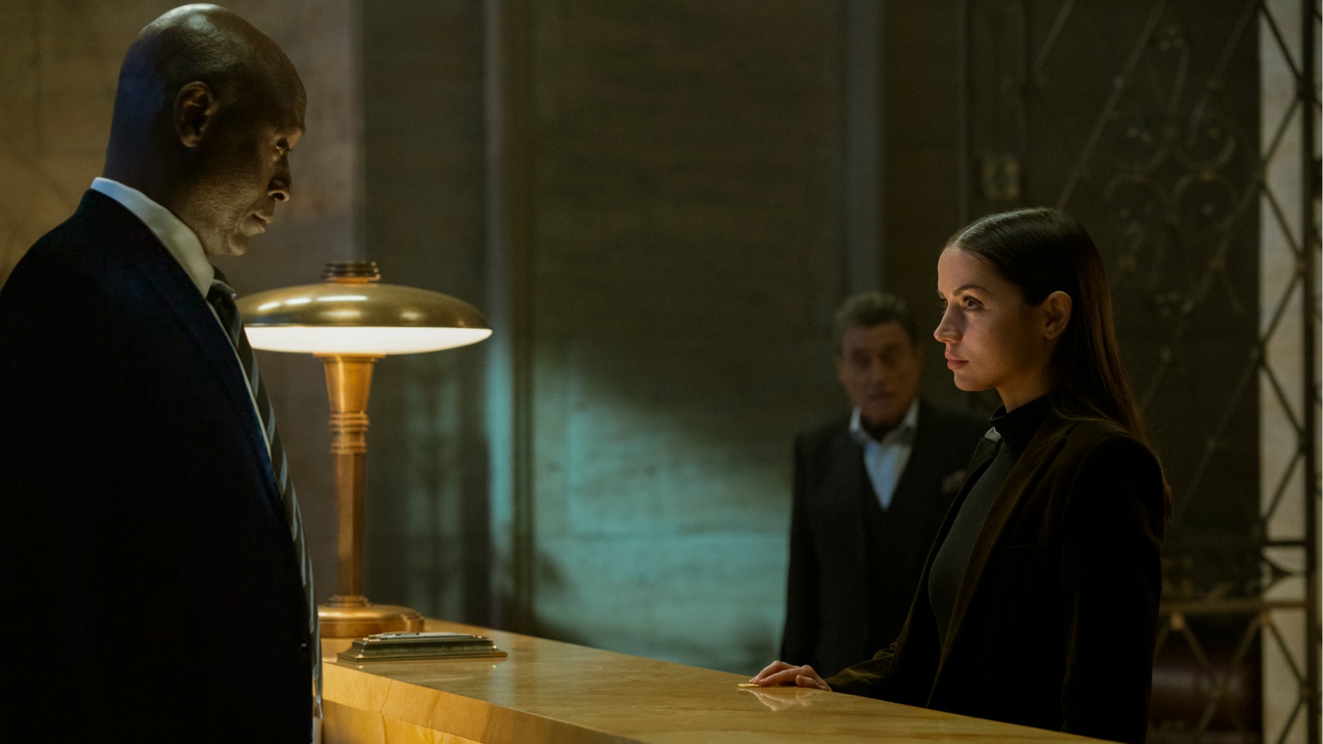 Lance Reddick and Ana de Armas as Charon and Eve in Ballerina
