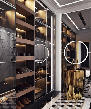 A mirrored walk-in closet in a dark finish, graphic tiled floor, gold basin