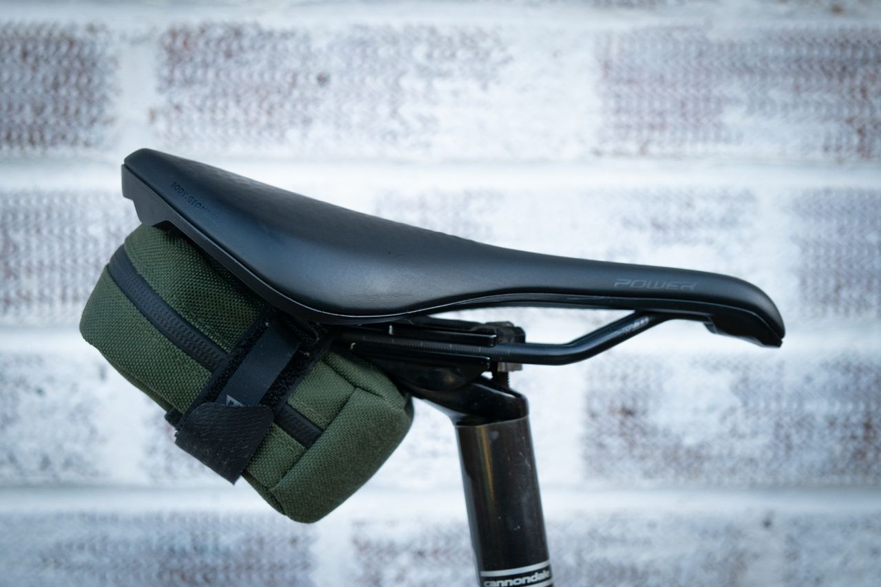 Small Topeak Elementa seat bag in green attached to saddle rails