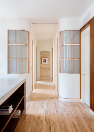 a hallway with internal glass windows