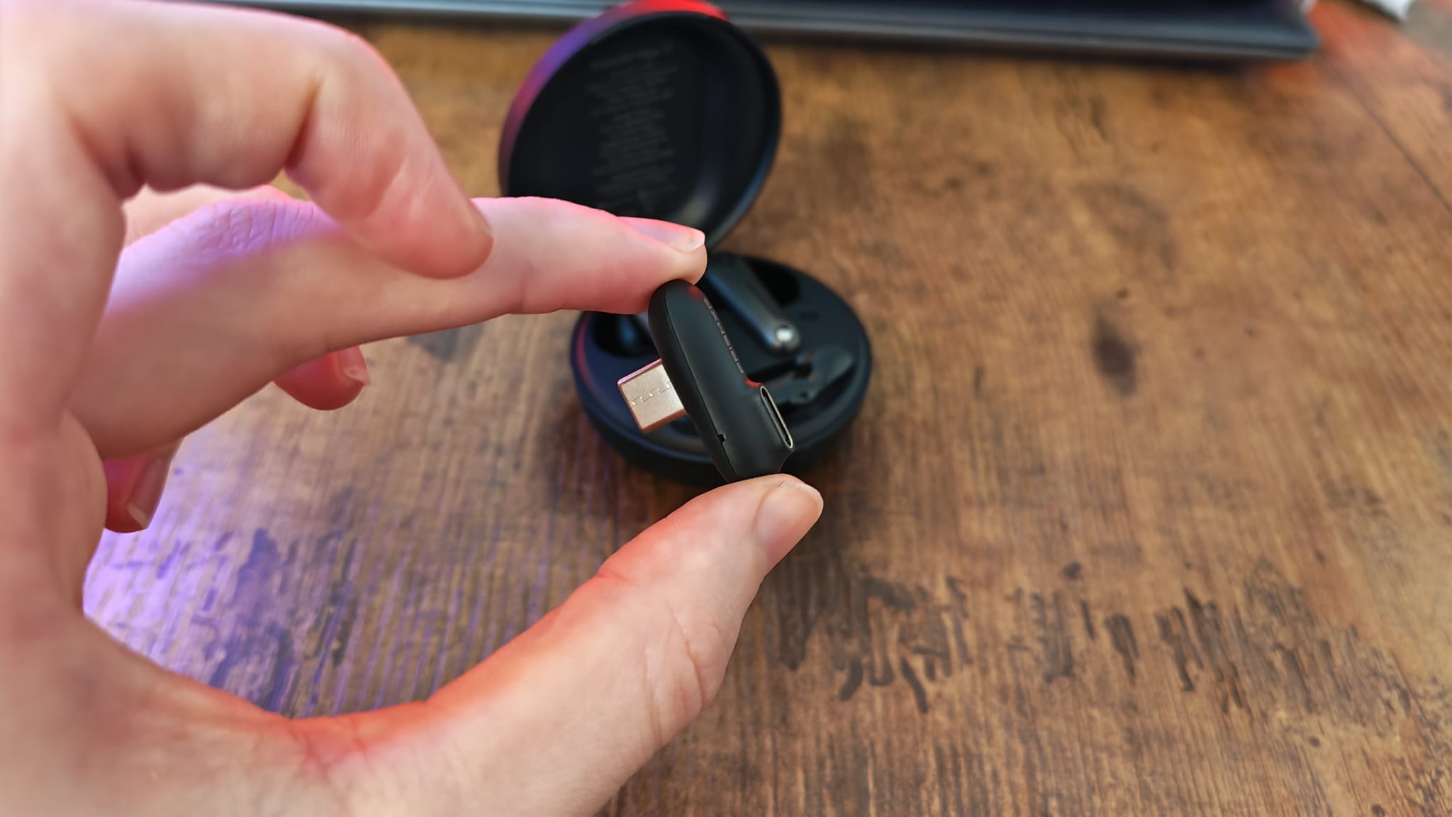 The shape of the dongle for the PrismXR Vega T1 earbuds