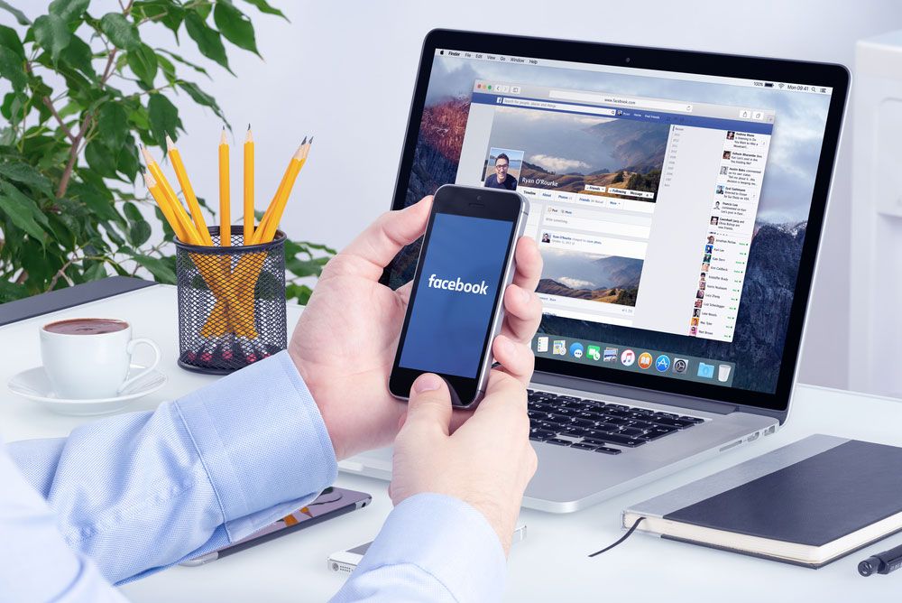 Facebook on a smartphone and a MacBook at the same time.