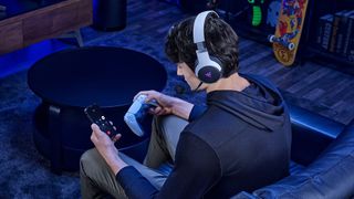 Man pairing Razer Kaira Pro for PS5 with phone