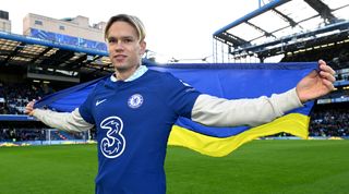 New Chelsea signing Mykhailo Mudryk holds the Ukrainian flag as he is unveiled to fans on the pitch during half-time of the Premier League match between Chelsea and Crystal Palace on 15 January, 2023 at Stamford Bridge in London, United Kingdom.